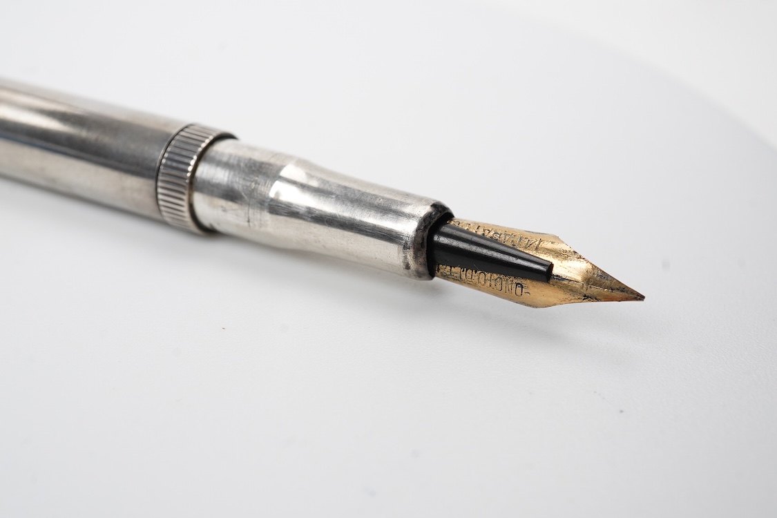 A De la Rue Onoto Sterling silver piston filler with fine flexible nib and over-and-under feed
